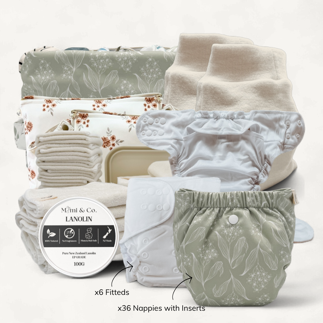 Stack of cloth diapers with floral patterns on a white background